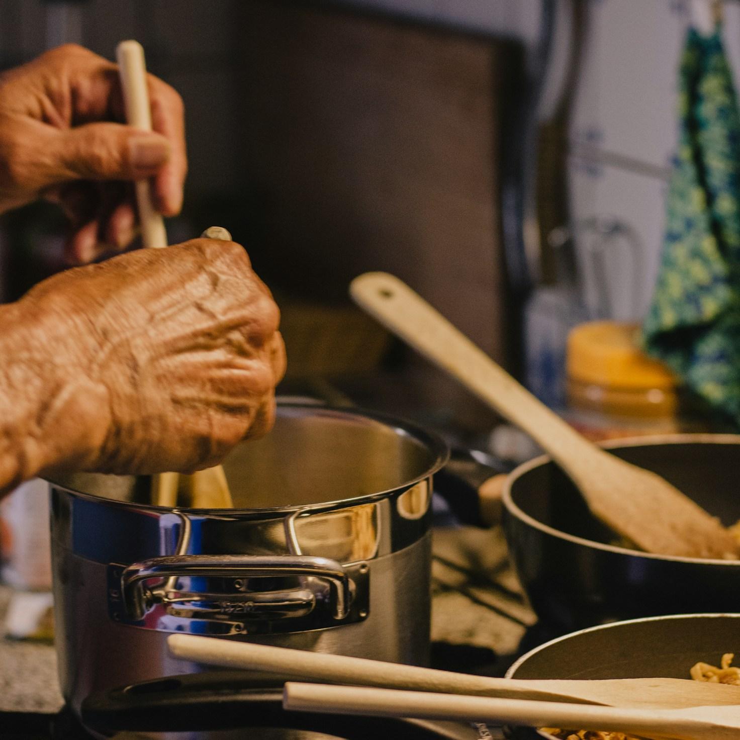 Diverse group of community members sharing a meal together, showcasing the social bonds formed through collaborative cooking